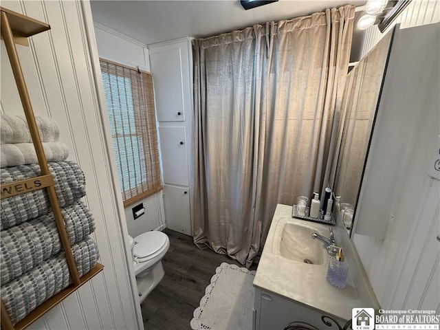 bathroom with wood-type flooring, toilet, and vanity