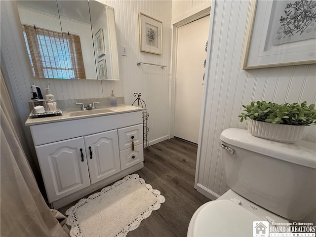 bathroom with vanity, wood-type flooring, and toilet