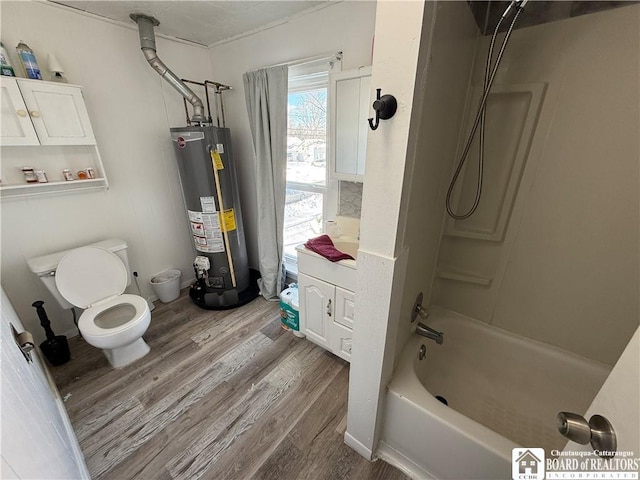 bathroom with hardwood / wood-style flooring, toilet, tub / shower combination, and gas water heater