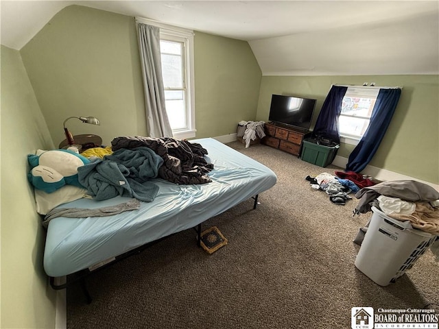 carpeted bedroom with lofted ceiling