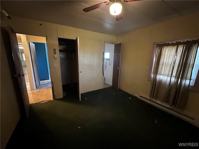 bedroom featuring baseboard heating, ceiling fan, and carpet floors