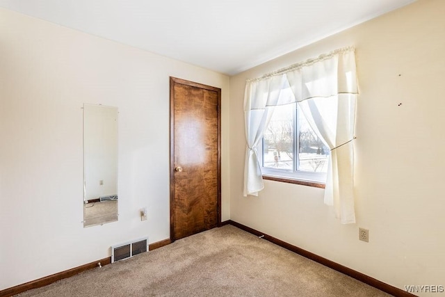 empty room featuring light colored carpet