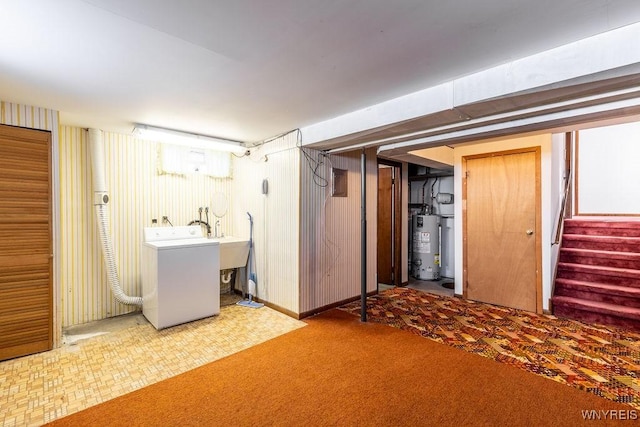 basement featuring washer / clothes dryer, carpet, and gas water heater