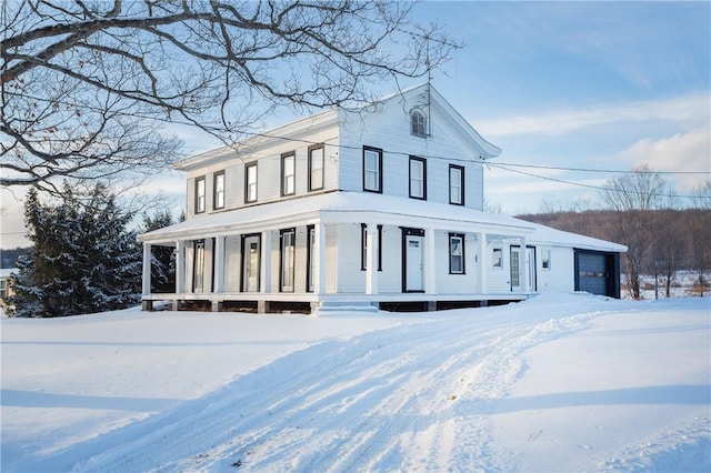 view of front facade featuring a porch and a garage