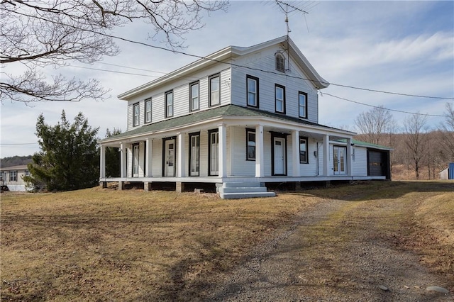 farmhouse with a front lawn and a porch