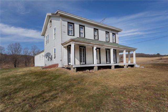 farmhouse inspired home with covered porch and a front yard
