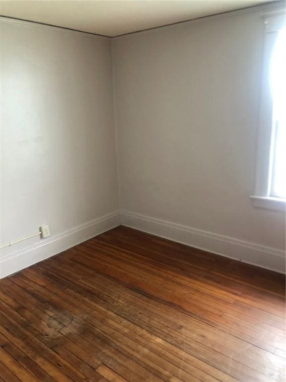 spare room with dark wood-type flooring