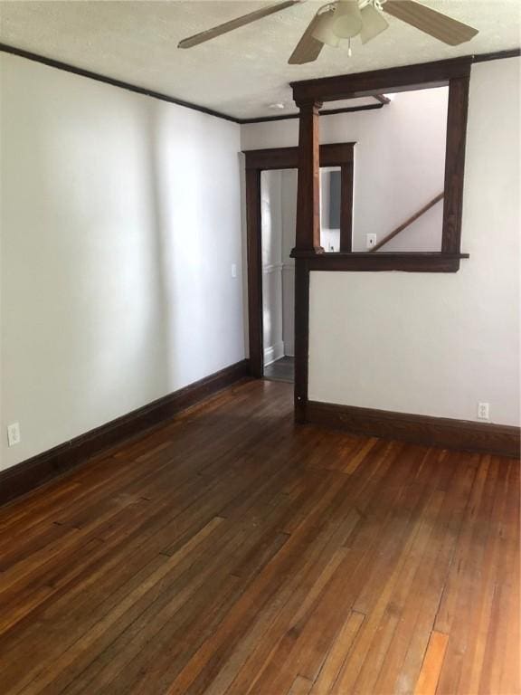 unfurnished room with dark wood-type flooring and ceiling fan