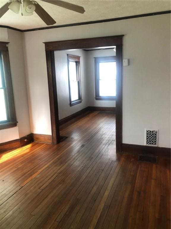 empty room featuring ceiling fan and dark hardwood / wood-style floors