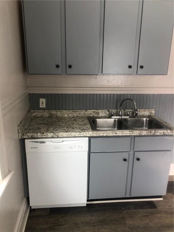 kitchen featuring dark hardwood / wood-style floors, dishwasher, and sink