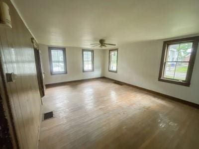 unfurnished room with hardwood / wood-style floors and ceiling fan