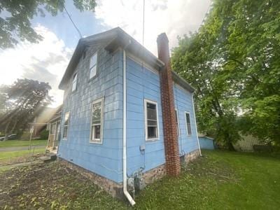 view of side of home with a lawn