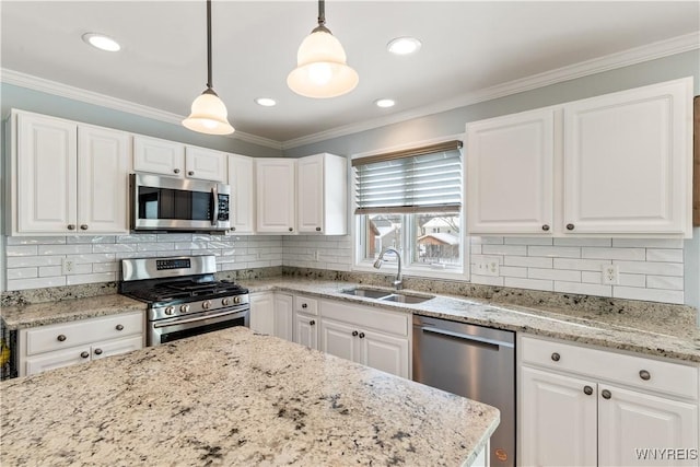 kitchen featuring appliances with stainless steel finishes, decorative light fixtures, white cabinetry, sink, and decorative backsplash