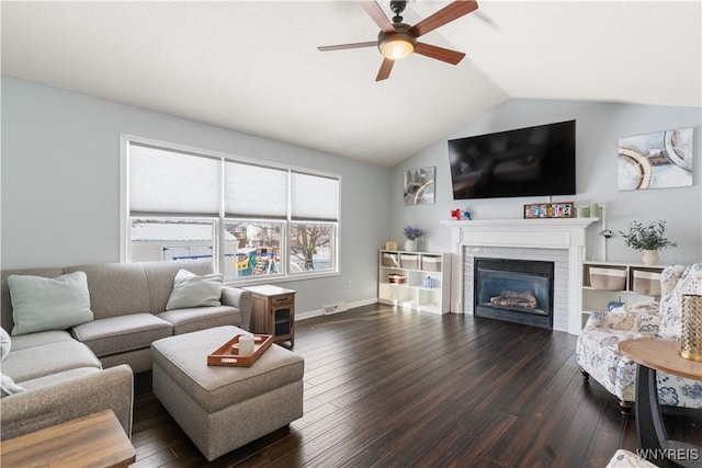 living room featuring dark wood-type flooring, ceiling fan, and vaulted ceiling