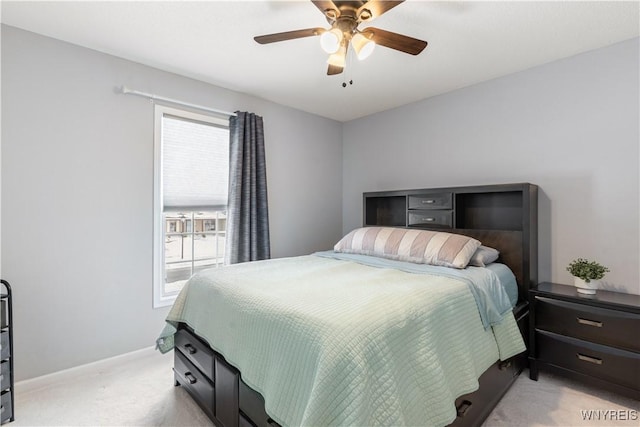 bedroom featuring multiple windows, ceiling fan, and light carpet