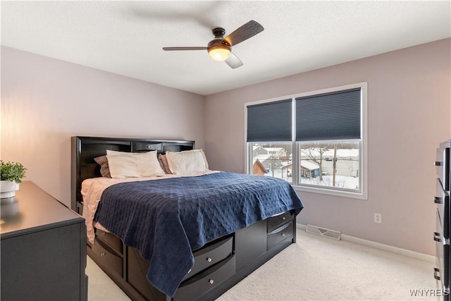 bedroom with light colored carpet and ceiling fan