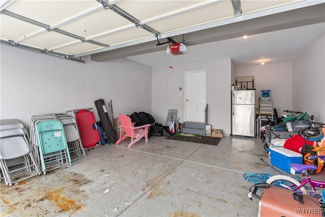 garage featuring a garage door opener and stainless steel fridge