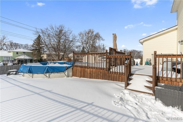 snow covered deck with a covered pool