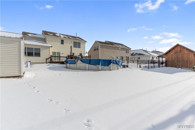 yard covered in snow featuring a swimming pool side deck