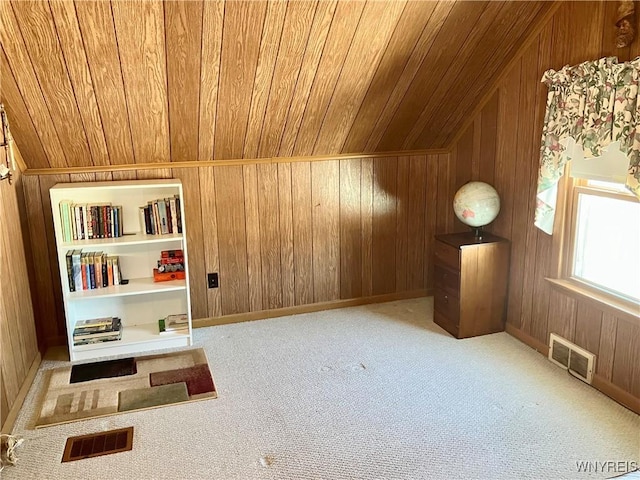 bonus room with wood ceiling, light colored carpet, and wood walls