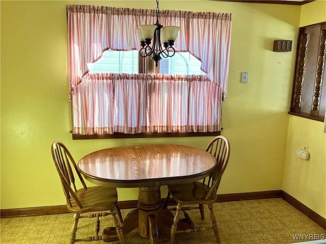 dining area with an inviting chandelier