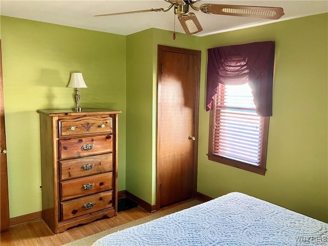 bedroom with light hardwood / wood-style floors and ceiling fan