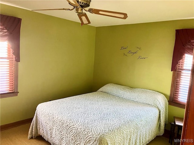 bedroom featuring ceiling fan and carpet