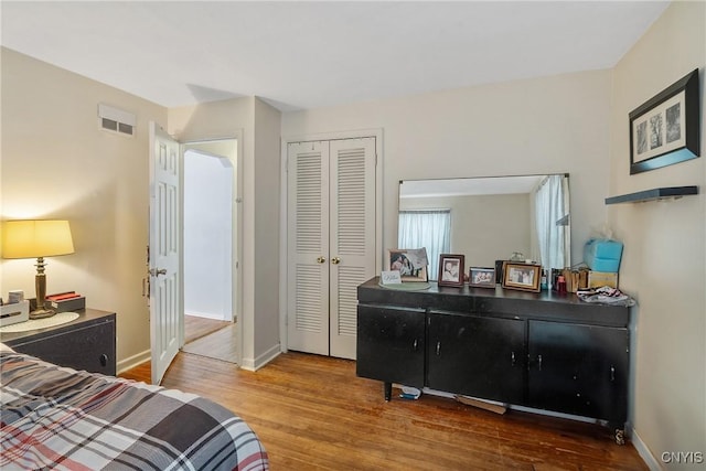 bedroom with hardwood / wood-style flooring and a closet