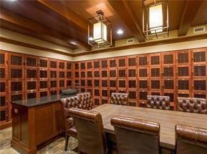 wine cellar featuring beamed ceiling