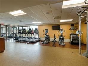 workout area with a paneled ceiling