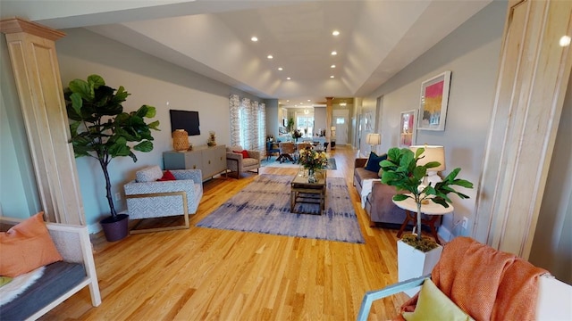 interior space featuring decorative columns and light hardwood / wood-style flooring