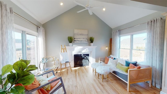 sitting room with vaulted ceiling, a wealth of natural light, ceiling fan, and light hardwood / wood-style flooring