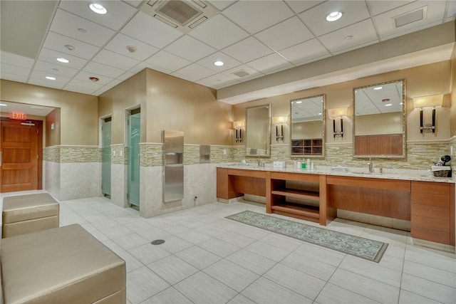 bathroom with vanity, tile patterned flooring, and a drop ceiling