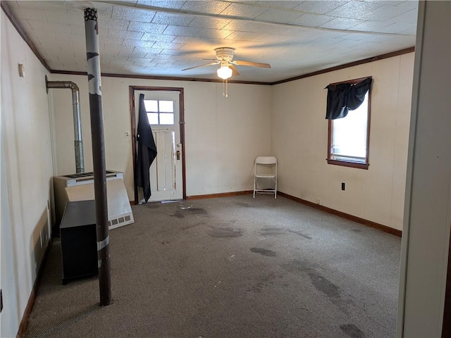 interior space with ornamental molding, carpet flooring, and ceiling fan