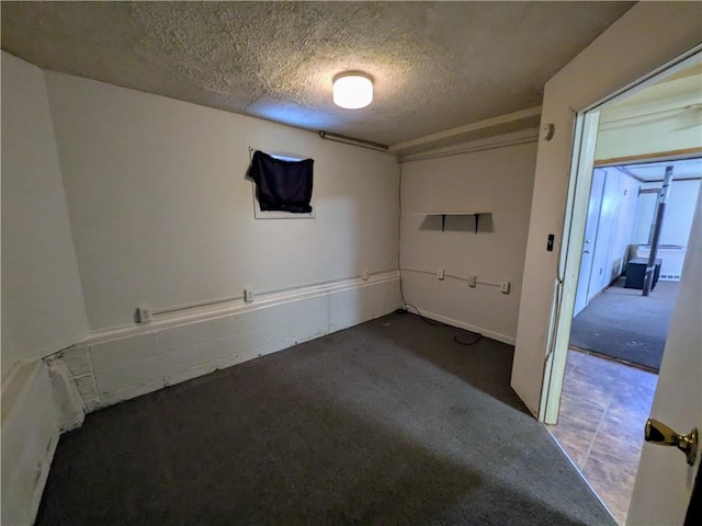 unfurnished room featuring a textured ceiling