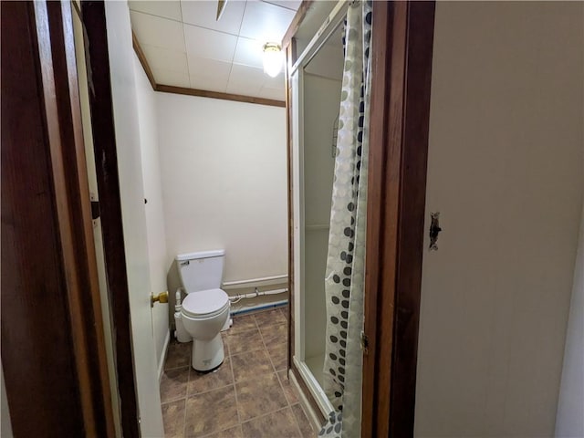 bathroom with ornamental molding, an enclosed shower, and toilet