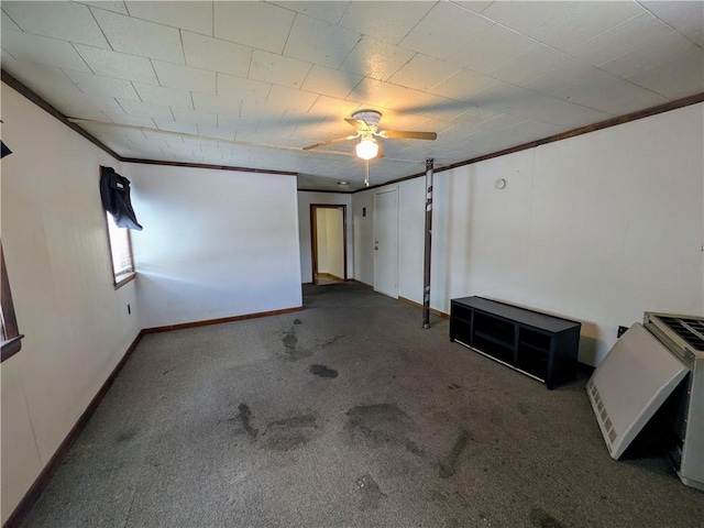 spare room featuring crown molding, carpet flooring, and ceiling fan