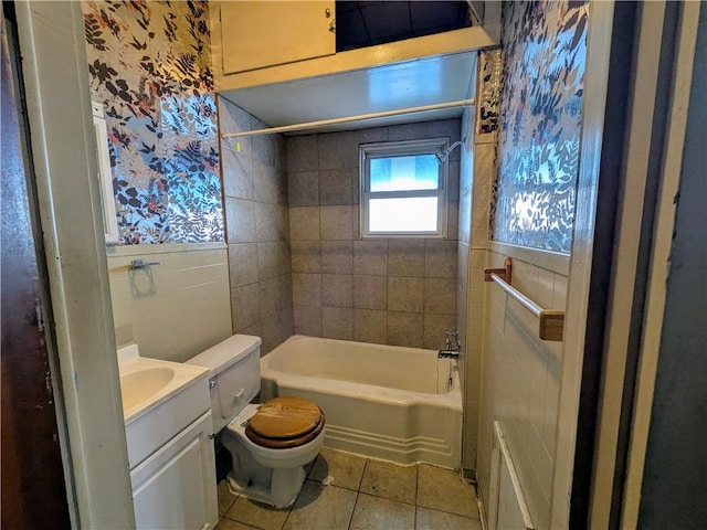 full bathroom featuring tiled shower / bath combo, vanity, tile patterned floors, and toilet