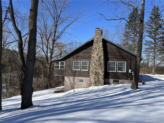 view of snow covered back of property