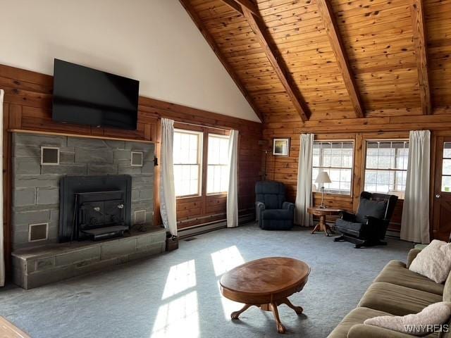 carpeted living room with a stone fireplace, high vaulted ceiling, wood walls, wood ceiling, and beam ceiling