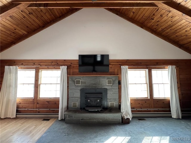 unfurnished living room featuring wood ceiling, a baseboard radiator, and a healthy amount of sunlight