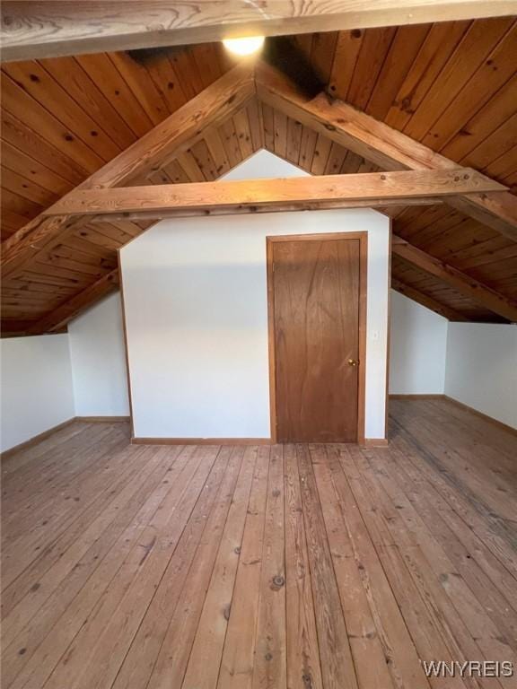 bonus room with hardwood / wood-style flooring, vaulted ceiling with beams, and wooden ceiling