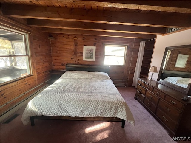 bedroom with wooden walls, beamed ceiling, dark carpet, baseboard heating, and wooden ceiling