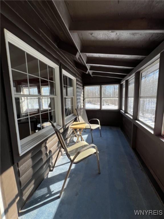 sunroom featuring beamed ceiling