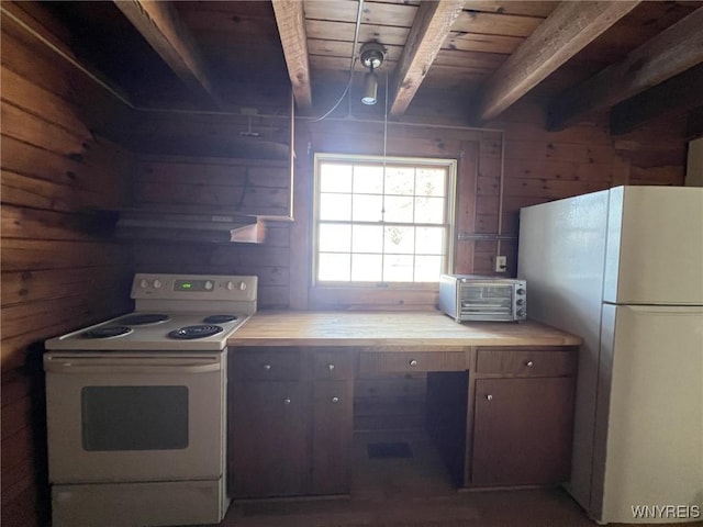 kitchen featuring butcher block countertops, white appliances, wood walls, and beam ceiling