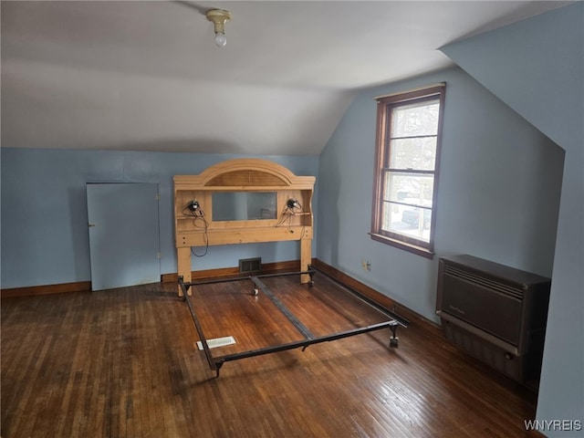 additional living space with vaulted ceiling and dark wood-type flooring