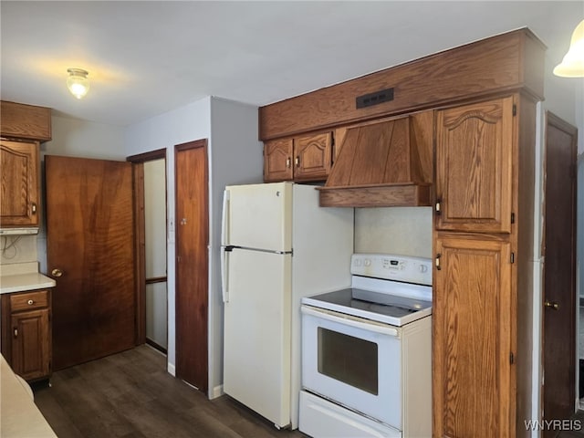 kitchen with premium range hood, white appliances, and dark wood-type flooring