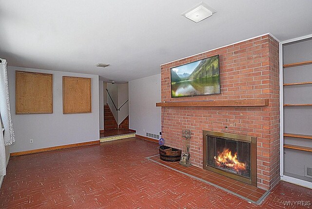 unfurnished living room with a brick fireplace