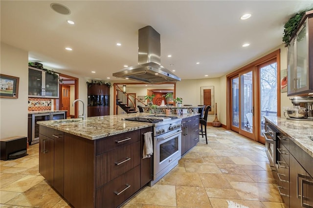 kitchen featuring sink, beverage cooler, island exhaust hood, high end stainless steel range, and a spacious island