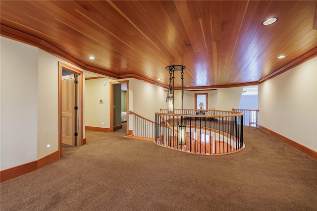 hallway with ornamental molding and carpet floors